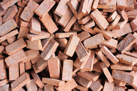 Many bricks are piled randomly in a pile