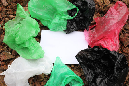 A bunch of reusable, multi-colored plastic bags polluting the environment. The concept of...