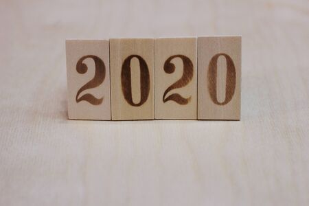 New year 2020 lined with wooden figures on the wooden surface. Happy New Year.の写真素材