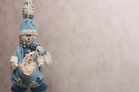 decorative rat sitting in his pocket at a knitted snowman on a gray background. Happy New year. Chinese horoscope. year of rat 2020. Copy space.の写真素材