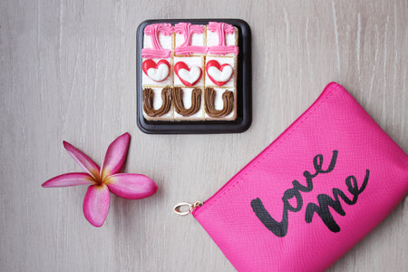Cakes with the design -I love you-, frangipani flower and cosmetic bag with the inscription-Love me....