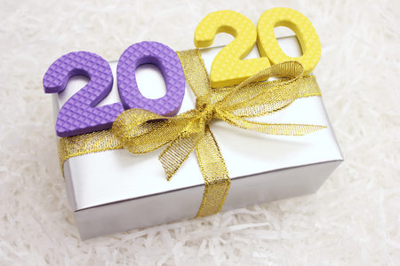 2020 colored numbers on the gift box. The concept of Christmas and the New year.