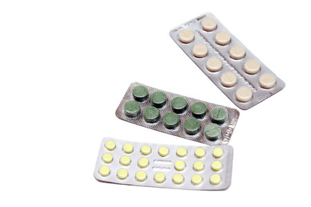 Tablets in blisters are isolated on a white background. Medicines. The concept of medicine and...