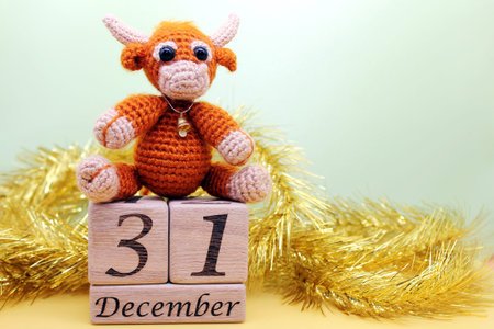 Toy bull. Symbol of the new year 2021. Date December 31 on wooden blocks. Happy New Year.の写真素材