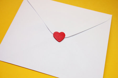 A red heart on a white postal envelope. The concept of love and Valentines Day.の写真素材