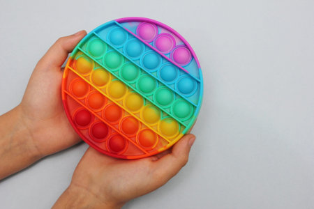 Popular modern anti-stress toy in children's hands.の写真素材