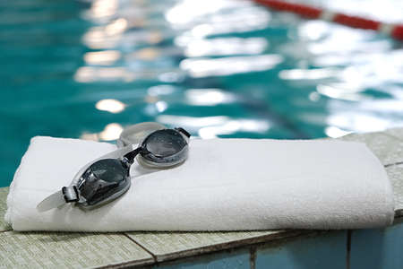 swimming pool. accessory for the pool - towel, swimming goggles.の写真素材