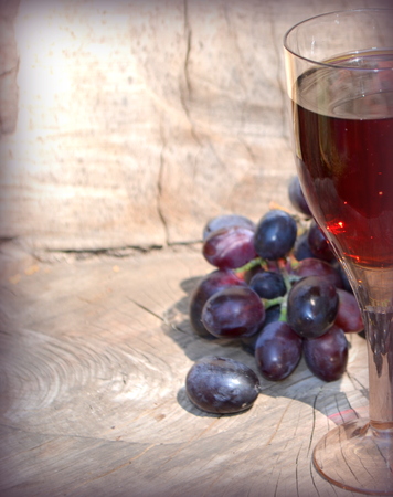 Glass of red wine and grapesの写真素材