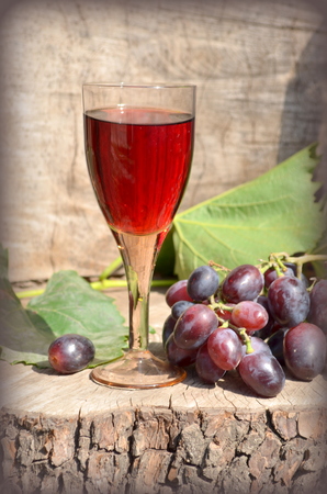 Glass of red wine and grapesの写真素材