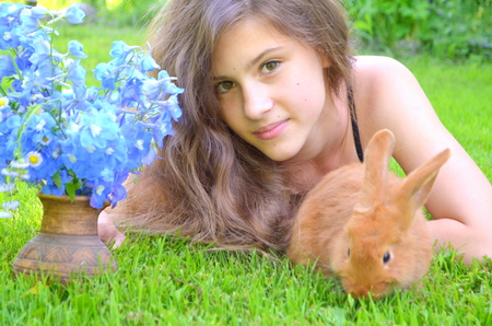 happy girl with the red rabbit outdoorsの写真素材