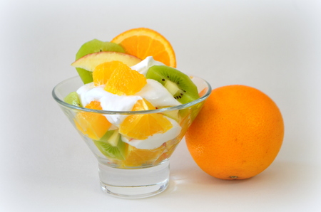 Dessert - fruit with cream, kiwi, apple and orangeの写真素材