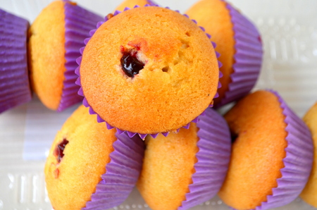 Muffin with black currant on white backgroundの写真素材