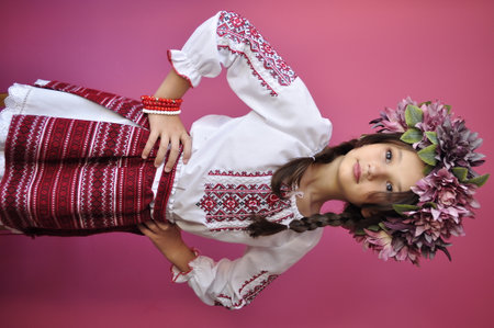 Young girl in Ukrainian national clothes, studio shot on pink background.の写真素材