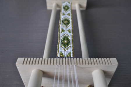 The bracelet features a traditional pattern with colorful beadsの写真素材