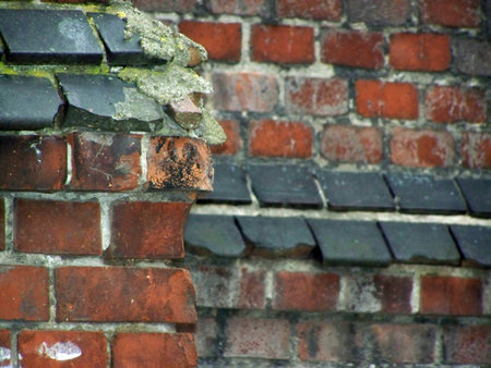 The wall is old red brick. The architecture is old. The photo