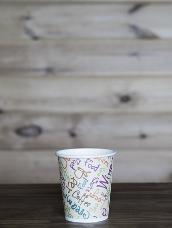 Empty paper cup at wooden tableの写真素材