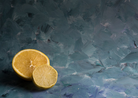 Orange and lemon at blue backgroundの写真素材