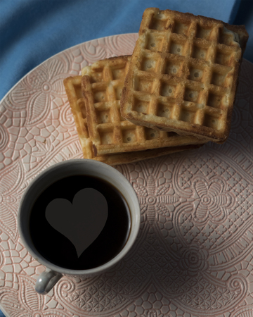 Cup of coffee with heart and wafflesの写真素材