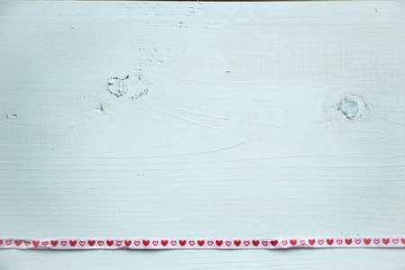 White rustic wooden background, painted with line of hearts