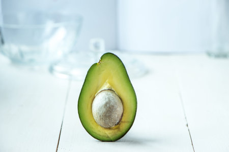 Avocado fruit at rustic white wooden background