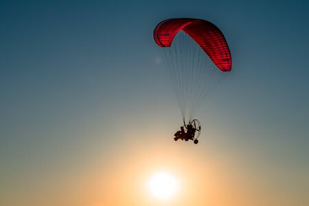 A paraglider soars in the skyの写真素材