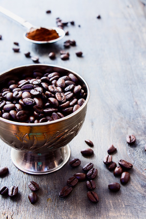 Coffee beans on grunge wooden background. Selective focus.の写真素材