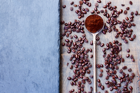 Coffee beans and vintage spoon on grunge dark backgroundの写真素材