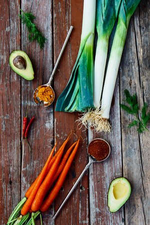 Fresh vegetables and spices on rustic wooden backgroundの写真素材