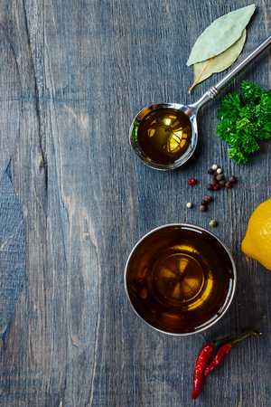 Spoon with Olive Oil and spices on wooden table. Top view.の写真素材
