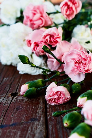 Bouquet of white and pink flowers on rustic wooden background. Selective focus.の写真素材