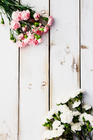 Colorful flowers on white wooden background. Top view.の写真素材