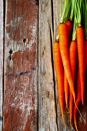 Top view of Fresh Organic Carrots on rustic wooden background.の写真素材