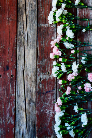 Top view of colorful flowers on vintage wooden background.の写真素材