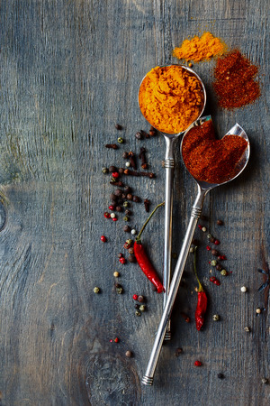 Bright spices over wooden backgroundの写真素材