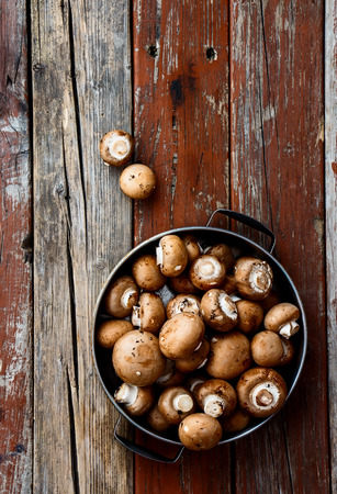 Organic whole mushrooms on rustic wooden background. Top view.の写真素材