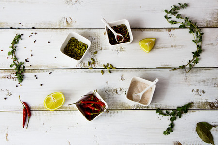 Spices and herbs selection over white wooden backgroundの写真素材
