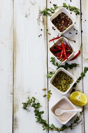 Aromatic spices and herbs over white wooden backgroundの写真素材