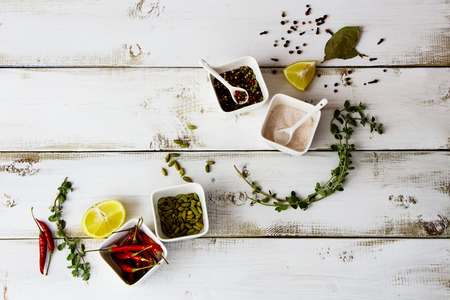 Food background with herbs and spices on white wooden board. Top view.の写真素材