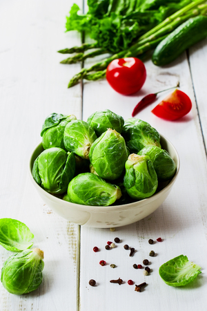 Healthy Organic Vegetables and Fresh brussel sprouts on White Wooden Backgroundの写真素材