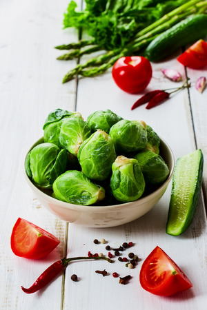 Organic fresh brussel sprouts and Healthy Organic Vegetables on White Wooden Backgroundの写真素材