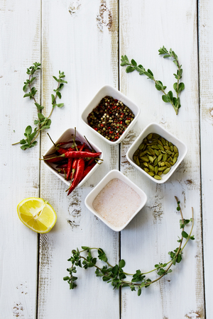 Spices and herbs over white wooden backgroundの写真素材