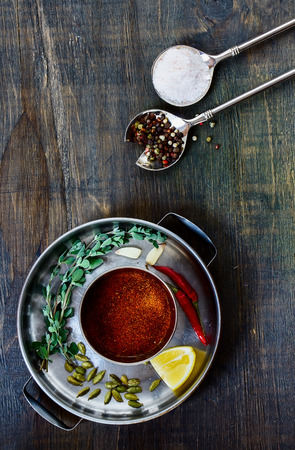 Various herbs and spices selection in vintage spoon on dark wooden board. Top view.の写真素材