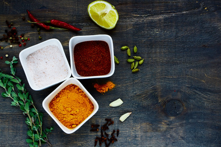 Close up spices and herbs selection on dark wooden backgroundの写真素材