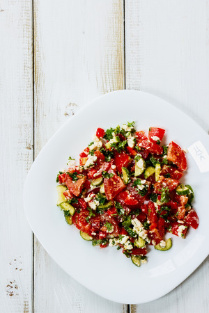 Mediterranean-style salad with vegetables and feta cheese. Top view.の写真素材