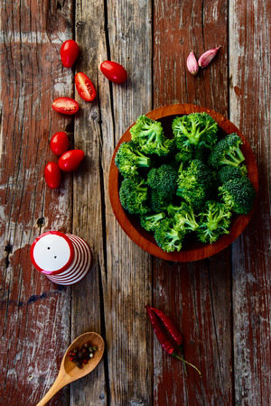 Green broccoli and Healthy Organic Vegetables on a Wooden Background. Top view.の写真素材