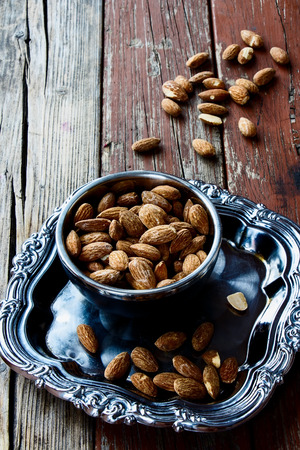 Almond nuts on vintage metal plate. Selective focusの写真素材