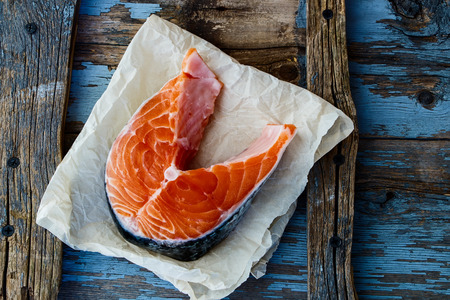 Fresh salmon steak on rustic wooden background. Top view.の写真素材