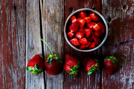 Fresh strawberries in bowl on Wooden Background. Summer or Spring Organic Berry over Wood. Agriculture, Gardening, Harvest Concept. Top view.の写真素材