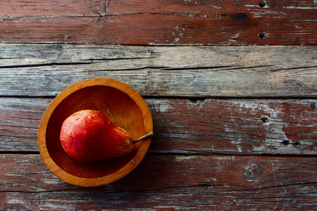 Ripe juicy pear in bowl on rustic wood. Pear autumn harvest. Fruit background. Top view. Copyspace.の写真素材
