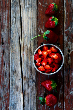 Top view of sweet strawberries in bowl on Wooden Background. Summer or Spring Organic Berry over Wood. Agriculture, Gardening, Harvest Concept.の写真素材